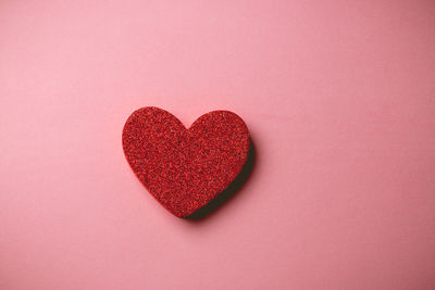 Close-up of heart shape against red background