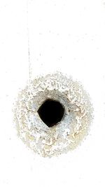 Directly above shot of hole on white background