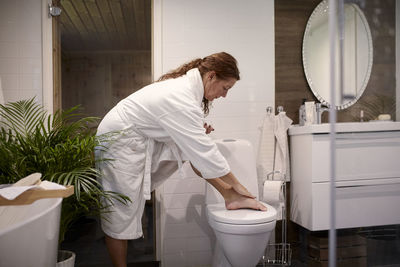 Woman applying moisturiser on her skin