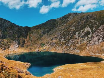 Scenic view of lake and mountains against sky