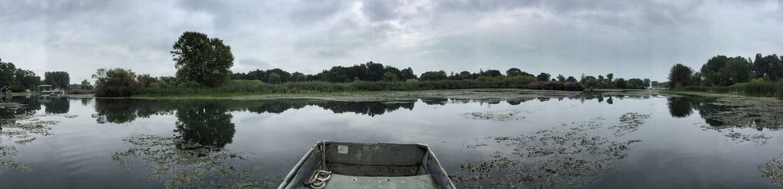 Panoramic shot of rowboat moored in canal