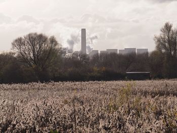 View of factory against cloudy sky