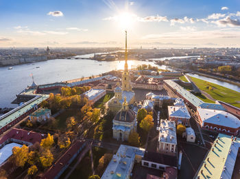 High angle view of cityscape by sea against sky