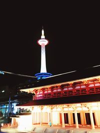 Low angle view of illuminated building against sky at night