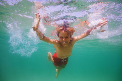 Young woman swimming in sea