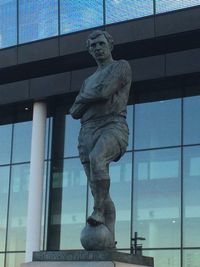 Low angle view of statue against historic building