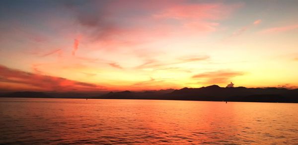 Scenic view of sea against romantic sky at sunset