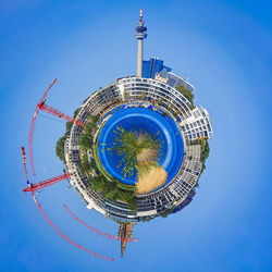 Little planet effect of olympiaturm and crane in city against sky