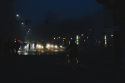 Cars on city street at night