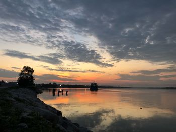 Scenic view of lake against sky during sunset