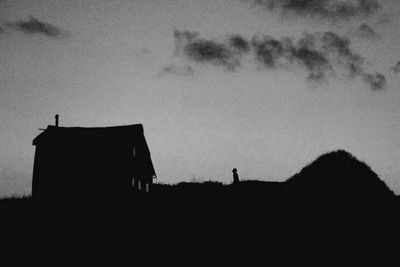 Low angle view of silhouette building against sky