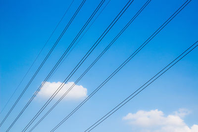 Low angle view of cables against blue sky