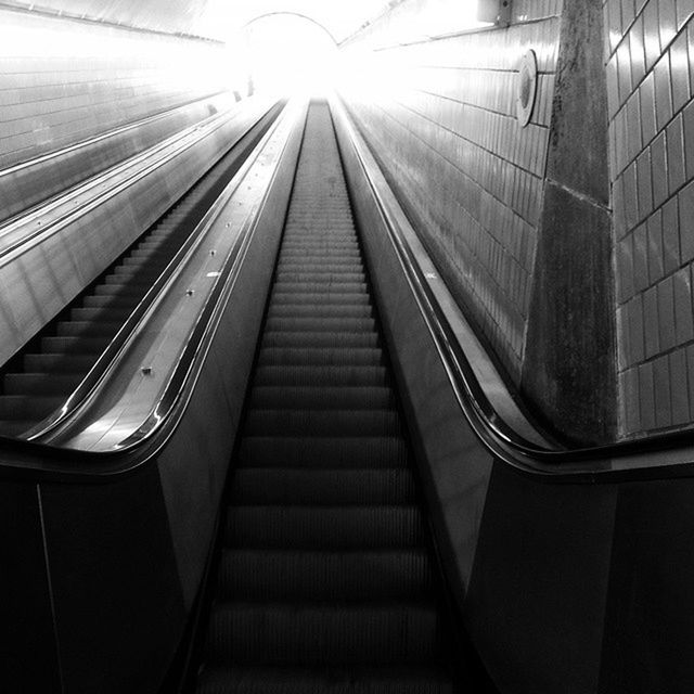 transportation, indoors, the way forward, diminishing perspective, rail transportation, modern, vanishing point, public transportation, escalator, architecture, built structure, railroad track, railing, travel, empty, technology, no people, mode of transport, train - vehicle, railroad station