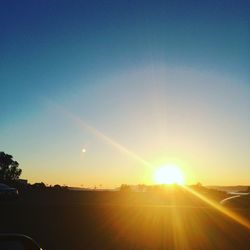 Scenic view of field against sky at sunset