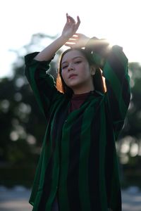 Full length of woman standing against wall