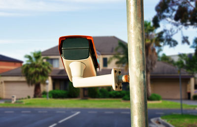 Close-up of vintage car on road against sky