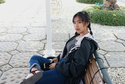 Portrait of woman sitting on bench