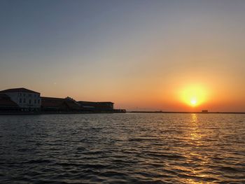 Scenic view of sea against orange sky