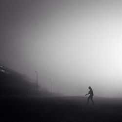 Full length of woman standing in foggy weather