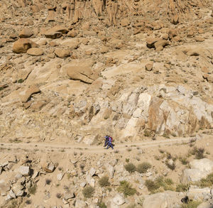 High angle view of man climbing on rock