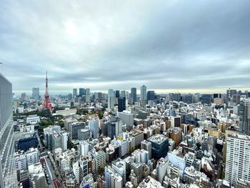 Aerial view of modern buildings in tokyo city against sky
