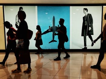 Silhouette people standing in corridor
