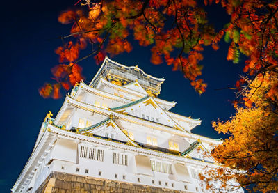 Low angle view of traditional building against sky during autumn