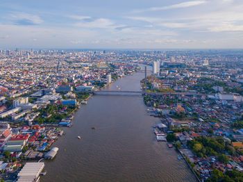 High angle view of buildings by canal against sky