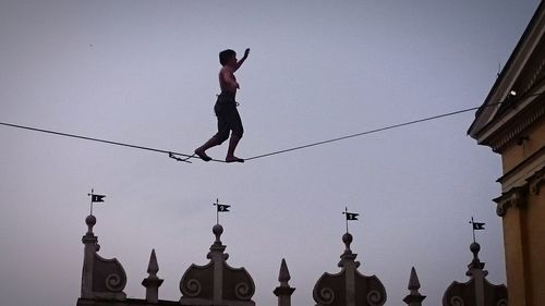 Low angle view of woman jumping in mid-air