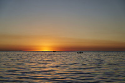 Beautiful golden sunset over lake titicaca with silhouette of a fisherman in a  boat, copa cabana