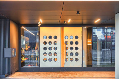 Low angle view of illuminated lighting equipment on wall