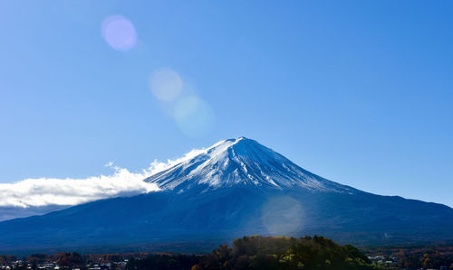 View of snowcapped mountain against blue sky