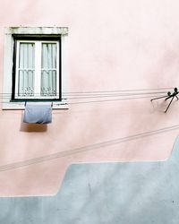 Low angle view of window on wall of building