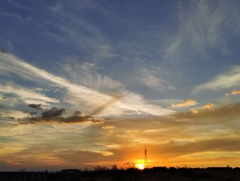 Silhouette buildings against sky during sunset