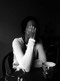 Midsection of person sitting on table