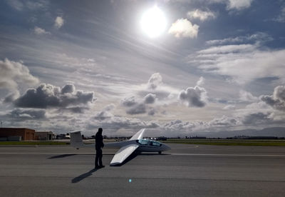 Airplane on runway against sky