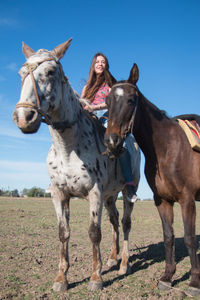 Young woman riding horse