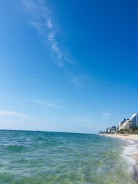 Scenic view of sea against blue sky