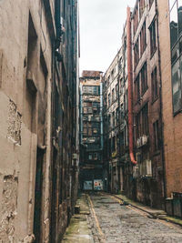 Narrow alley amidst buildings in city