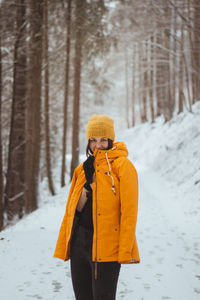 Portrait of young woman standing in forest