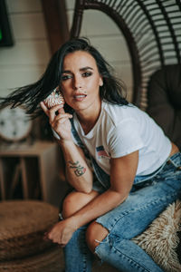 Portrait of beautiful woman sitting at home