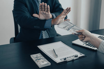 Low angle view of man holding hands on table