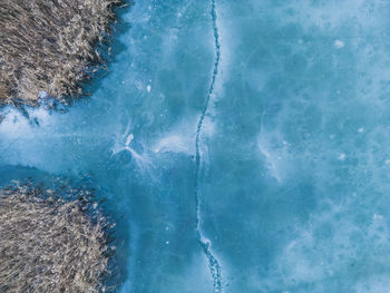 Aerial view of a frozen lake. ice sheet background. frozen waves on the lake. ice background. 