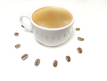 High angle view of coffee cup over white background