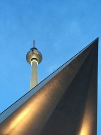 Low angle view of communications tower against sky