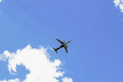 Directly below shot of commercial airplane in blue sky