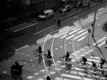 High angle view of people cycling on road in city