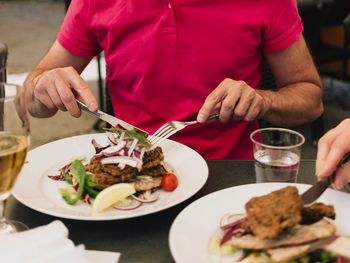 Midsection of man preparing food on table