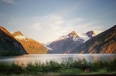 Scenic view of lake and mountains against sky