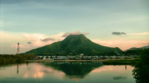 Scenic view of lake by mountains against sky